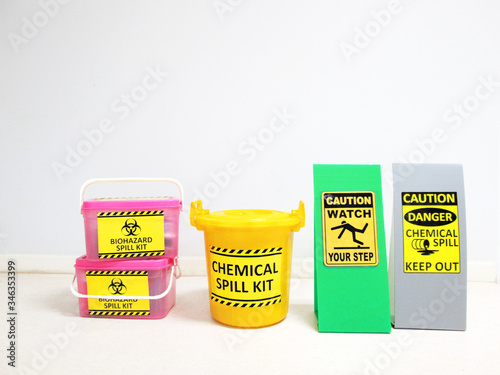 Chemical Spill kit yellow bucket and Biohazard Spill Kit with Warning danger caution hazard tag sign or symbol for emergency response situation when the chemical spill out, safety first in laboratory.