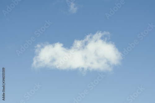 Single cloud flying in the deep blue sky 