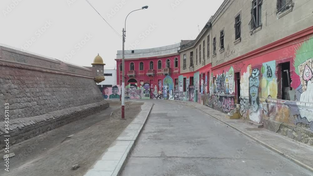 Drone flying in reverse between a old 1920`s colonial fortress called Real Felipe and homes in an emplty and calm street. Drone flying in reverse between a old 1920`s colonial fortress called Real Felipe and homes in an emplty and calm street.