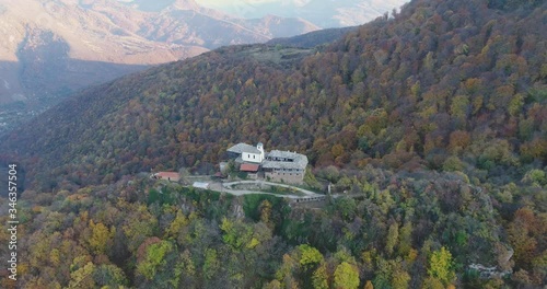 A flight in the autumn over a rocky monastery at the top of a mountain,, Glozhene Monastery, Bulgaria. photo