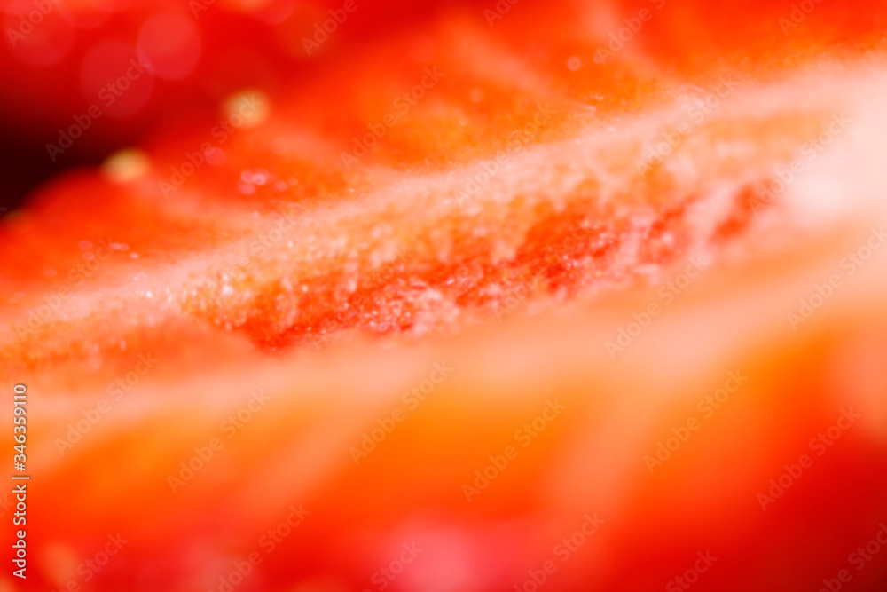 Blurred natural red background. Strawberry background. Texture of strawberries. Beautiful strawberry wedge close-up. Horizontal, close-up, nobody. Healthy eating concept. Blurred natural red background. Strawberry background. Texture of strawberries. Beautiful strawberry wedge close-up. Horizontal, close-up, nobody. Healthy eating concept.