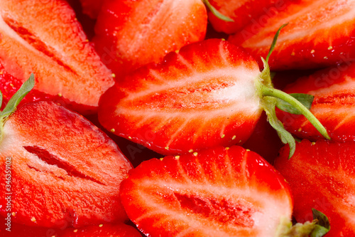 Fruit background. Strawberry background. Top view of strawberry slices. Texture of strawberry berries. Beautiful strawberry slices close up. Horizontal, close-up, nobody. Healthy eating concept.