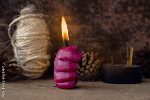 Burning candle in the shape of a hand