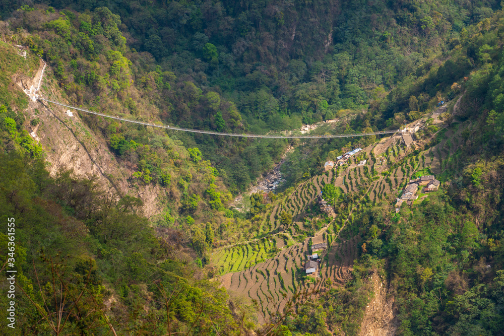 High angle view of the suspension bridge named 'New Bridge' (278 m long) located nearly Jhinu Danda village, one of the famous village on the way to Annapurna Sanctuary of Nepal.