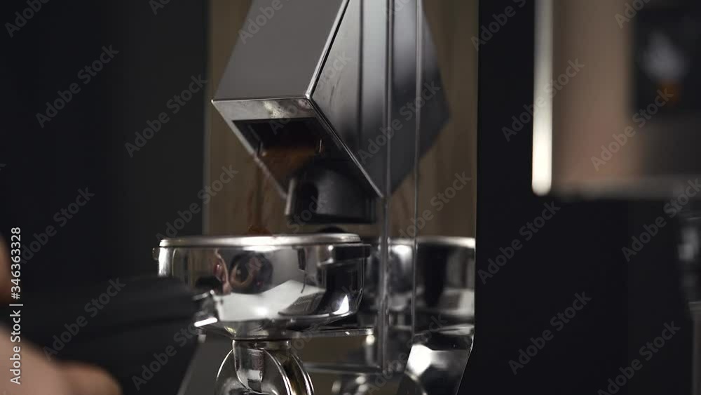 Grinding coffee on porta filter with coffee making machine