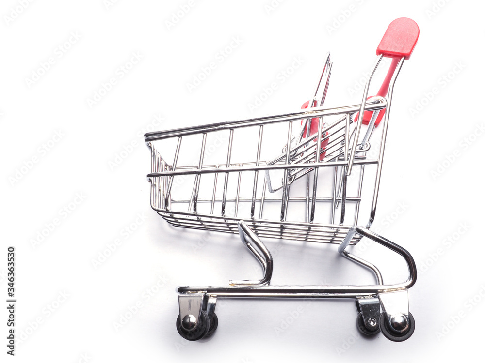 Small empty shopping cart or metal trolley on white background with space for text.Horizontal photo.