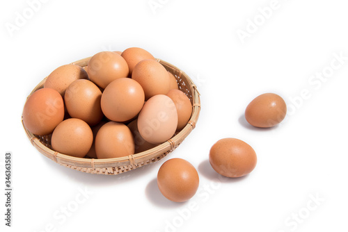 Eggs in a wooden basket on a white background.