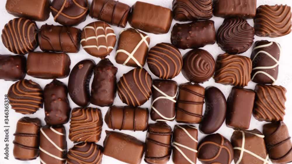 Delicious chocolates various shapes on marble background - Stop motion Delicious chocolates various shapes on marble background - Stop motion
