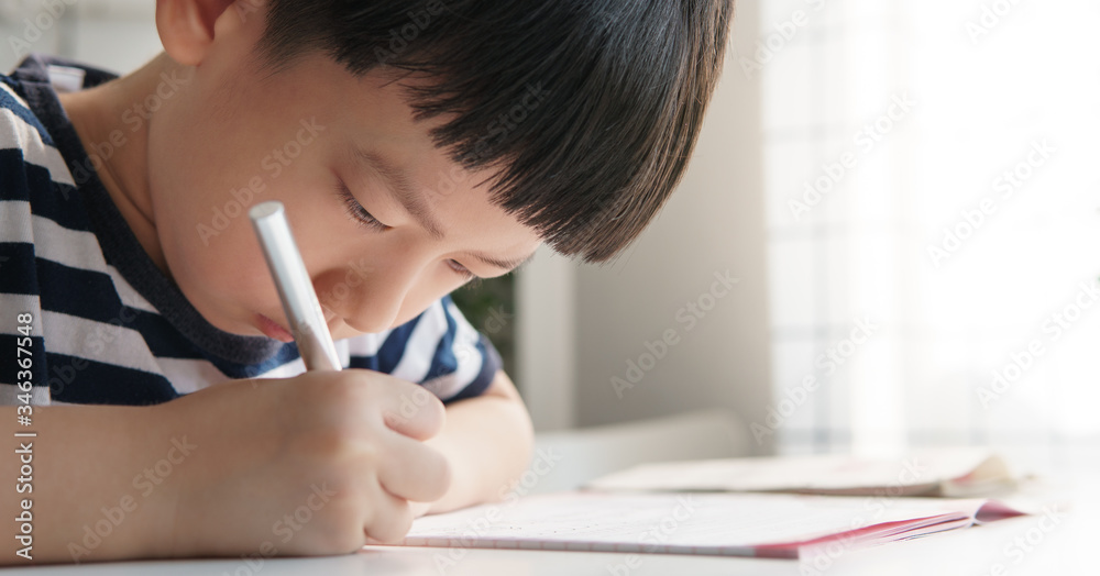 Closeup, Cute little Asian primary school boy study, draw and write homework on his desk in his room at home with focus and concentration. Early education and child development concept. Closeup, Cute little Asian primary school boy study, draw and write homework on his desk in his room at home with focus and concentration. Early education and child development concept.