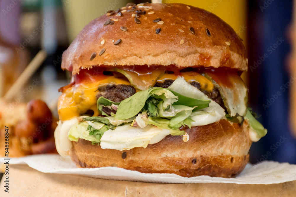 Fresh melting burger ready to eat during fast food festival. Outdoor catering event, brunch Fresh melting burger ready to eat during fast food festival. Outdoor catering event, brunch