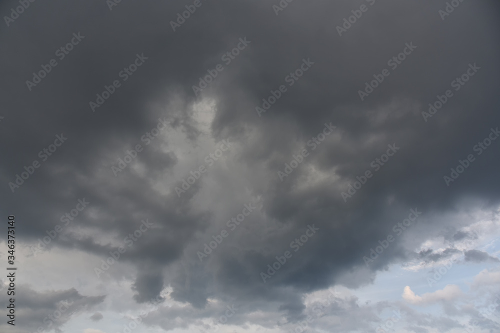 Rain clouds background. Clouds become dark gray like a big smoke before rainfall. Concept the rainy season Thunderstorm is a storm with lightning and thunder. Rain clouds background. Clouds become dark gray like a big smoke before rainfall. Concept the rainy season Thunderstorm is a storm with lightning and thunder.