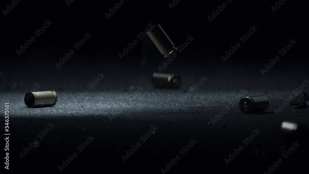 Sleeve Bullet Metal Slot on Dark Gray Asphalt Smoke Coming From the Bullets