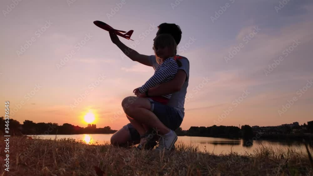 Father and daughter play in nature at sunset Father and daughter play in nature at sunset