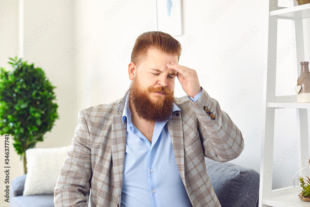 A man with a beard with a headache. A man with a beard with a headache.