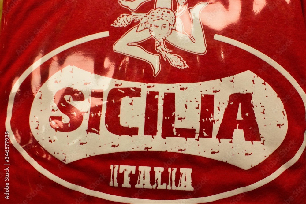 print on a red background of female head with three folded legs said