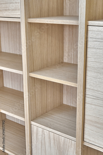 Wooden bookshelves. Wooden bookcases and wall panels made of oak veneered MDF