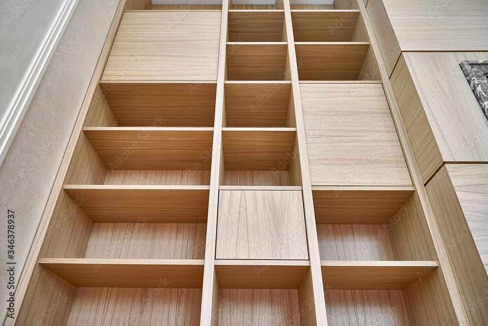 Wooden bookshelves. Wooden bookcases and wall panels made of oak veneered MDF