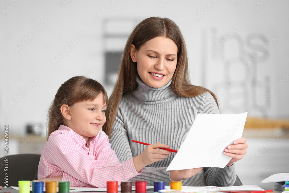 Drawing teacher giving private art lessons to little girl at home Drawing teacher giving private art lessons to little girl at home