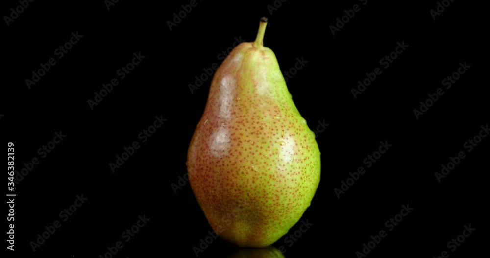 One fresh pear slowly rotates. One fresh pear slowly rotates.