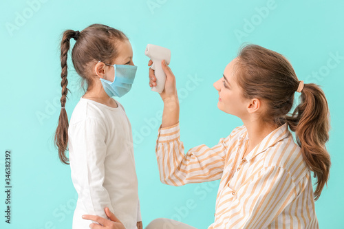 Mother measuring temperatur...
