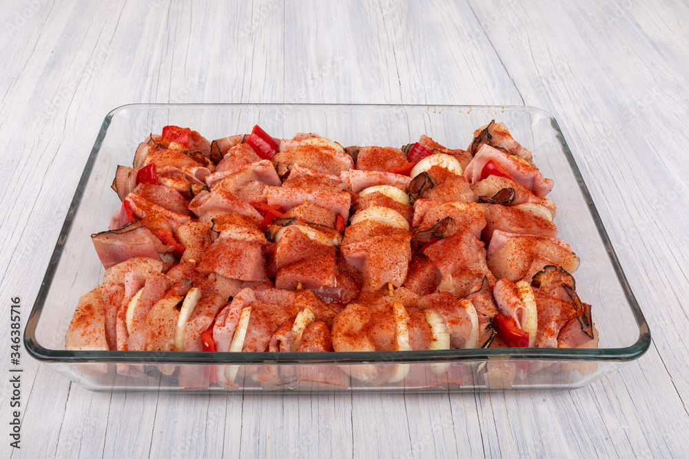 raw meat, chicken, bacon, pork, onion and hot spices on skewers ready for grill. raw meat, chicken, bacon, pork, onion and hot spices on skewers ready for grill.