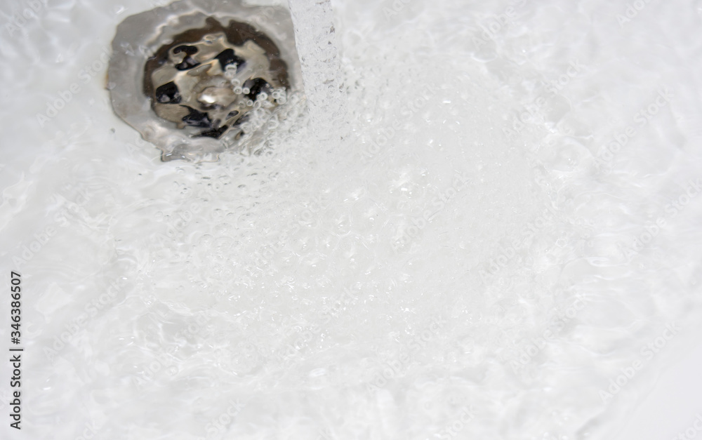 Water runs into the sink Water runs into the sink