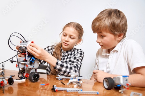 Young friends creating robot using building kit.