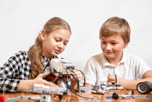 Young friends creating robot using building kit.