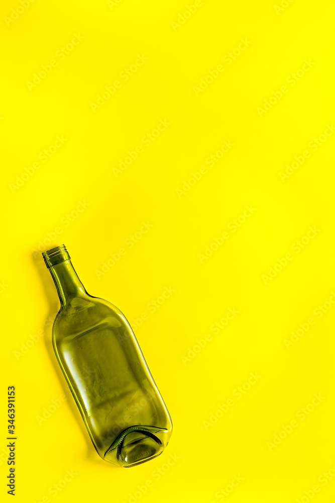 Fototapeta premium Empty bottle on yellow background top view copy space