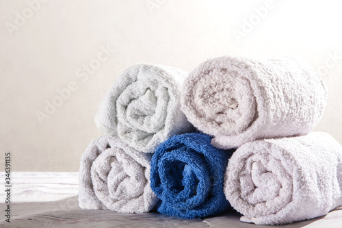 White and dark blue towels for bath rolled up