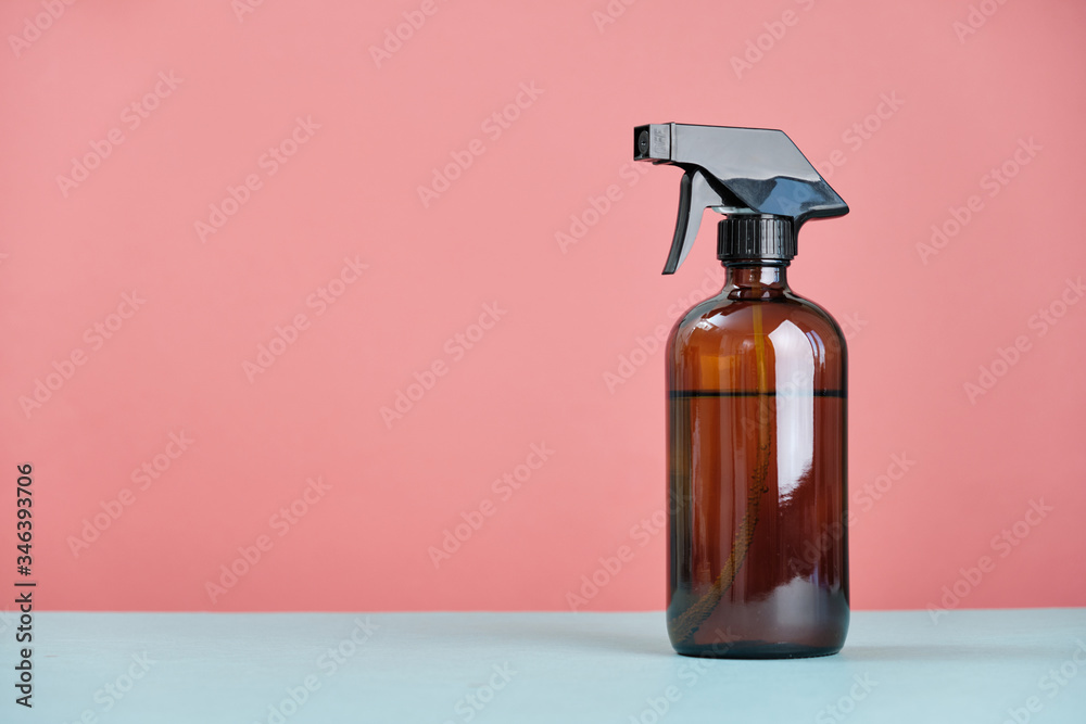 Glass sprayer on a table on a pink background. Glass sprayer on a table on a pink background.