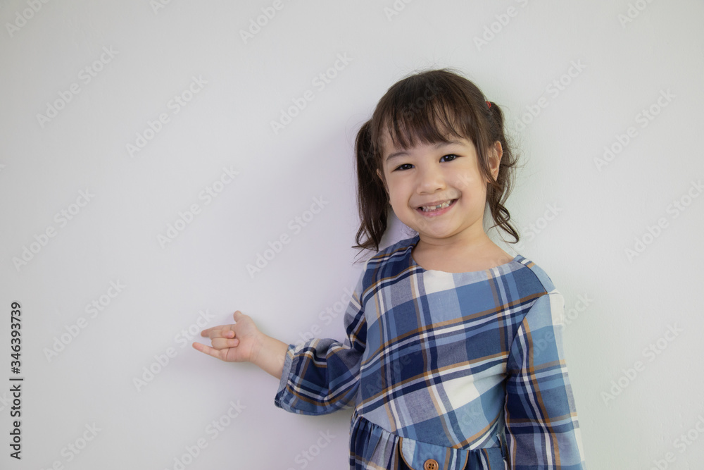 half-body and front-view photo of adorable, three-year-old Asian girl posing on a white background shows her brightness that makes people look happy, bright and cute. half-body and front-view photo of adorable, three-year-old Asian girl posing on a white background shows her brightness that makes people look happy, bright and cute.