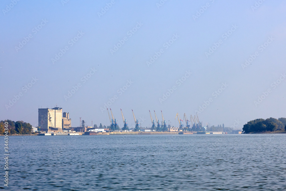 View of the port, port cranes and elevator building at Danube river