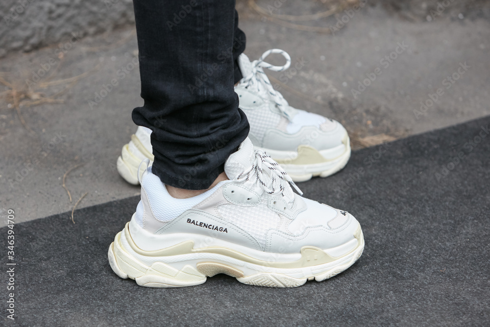 Derfra Duke deformation Man with white Balenciaga sneakers and black trousers on January 15, 2018  in Milan, Italy Stock Photo | Adobe Stock