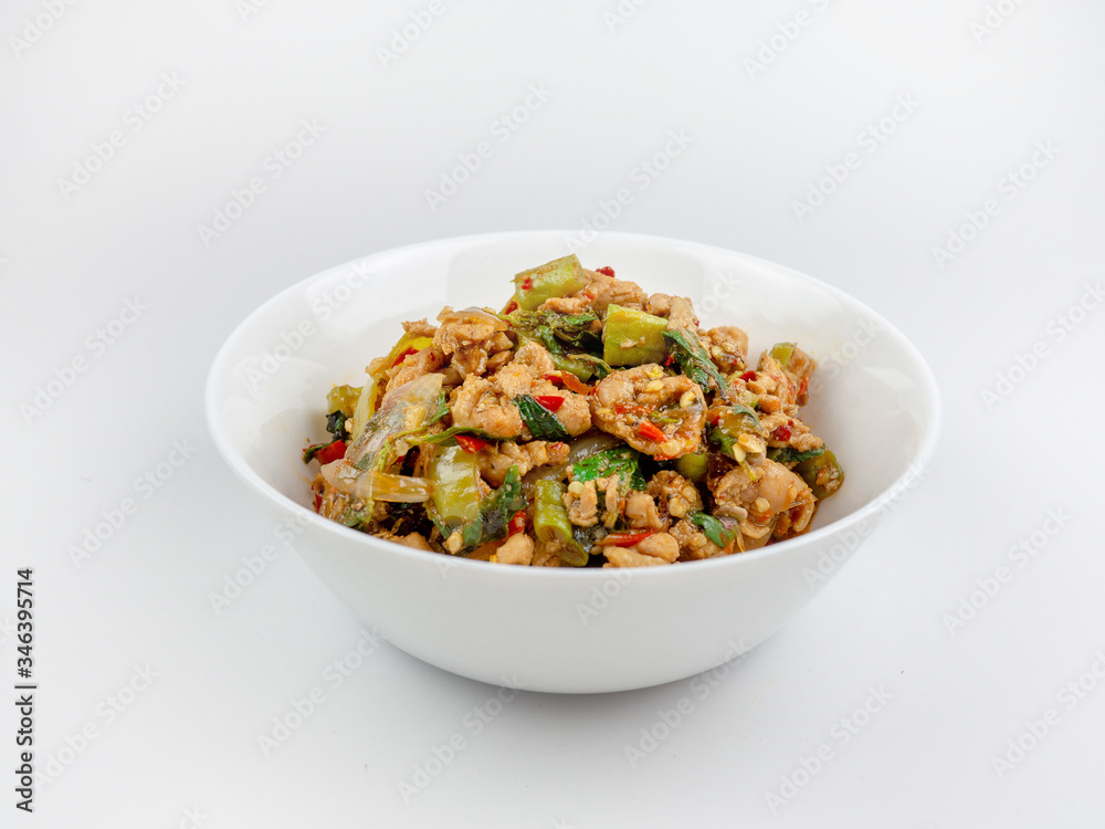 Stir-fried chicken with holy basil on white background., hot and spicy food Stir-fried chicken with holy basil on white background., hot and spicy food