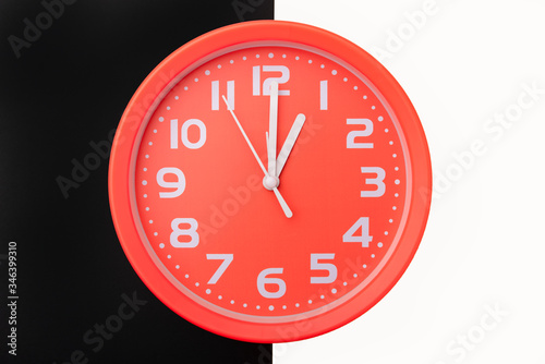 Clock on a black and white background: concept of a turning point