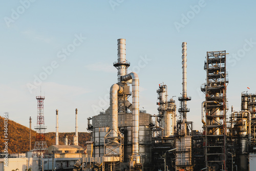 Oil and gas industrial, Oil refinery plant from industry, Refinery Oil storage tank and pipe line steel with blue sky and white clouds background.
