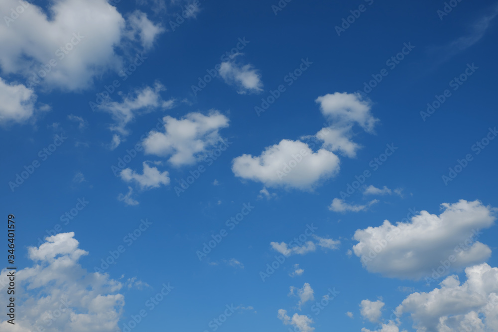 Little cumulus clouds on a blue sky. Background.