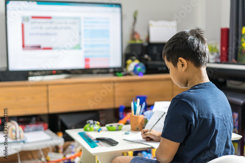 Asian kid distance learning online education with smart tv