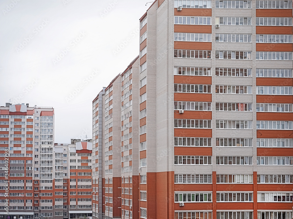 Brick multi-building residential house, urban background, wall with windows