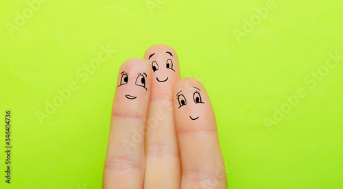 the concept of three fingers as a man a woman and a child hug together and love each other