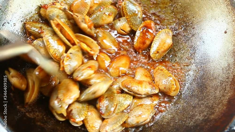 Frying clams with chili paste in pan , Thai famous food Frying clams with chili paste in pan , Thai famous food