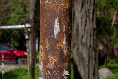 old rusty pillar stands on the street