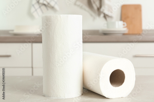 Rolls of paper towels on light grey marble table in kitchen