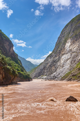 Rough waters at Tiger Leaping Gorge, one of the deepest and most spectacular river canyons in the world, located on the Jinsha River, primary tributary of the upper Yangtze River, China.