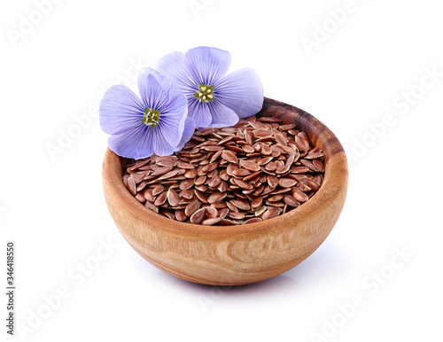 Flax seeds in wooden bowl on white background