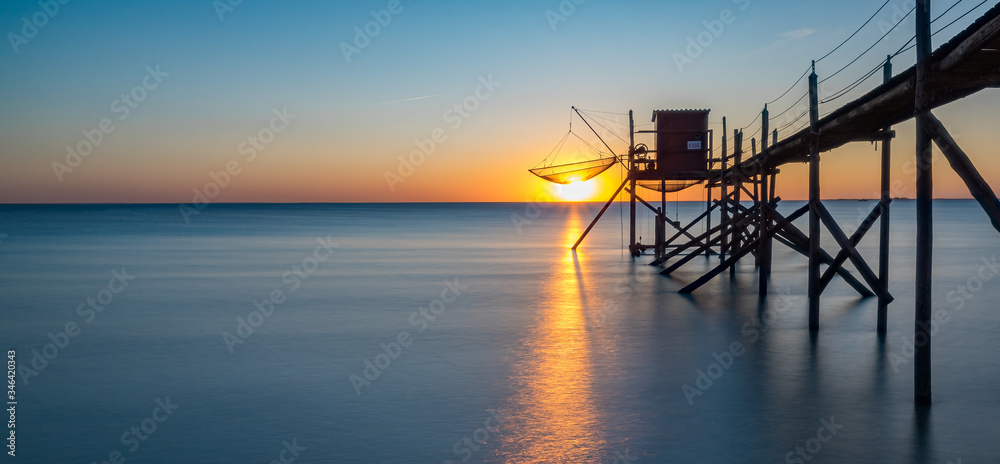 A fishing hut called carrelet at sunset
