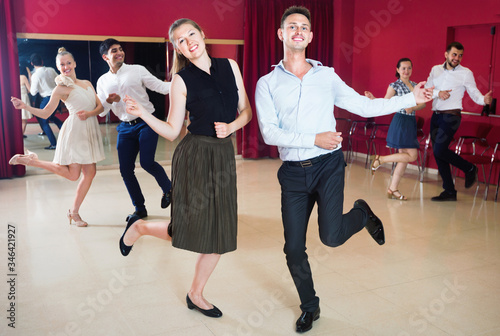 Positive people dancing twist in pairs