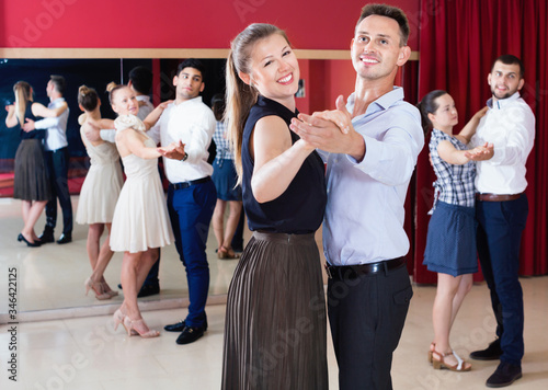People learning to dance waltz in dancing class