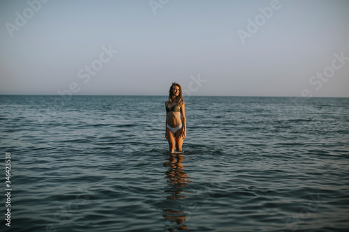 Young woman walking in water at the beach